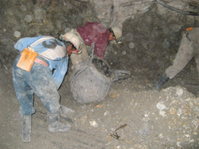 Potosi: loading ore bag For hoist to higher level., Bolivia 2007