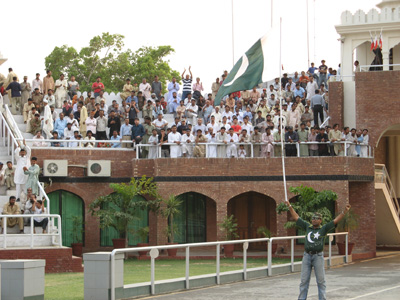 A Pakistani warm-up flag waver With patriotic crowd., Wagha, Pakistan 2008