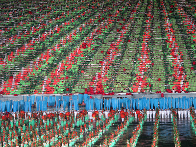 Tomatoes(?) roll down the flip-card array., North Korea - Mass Games