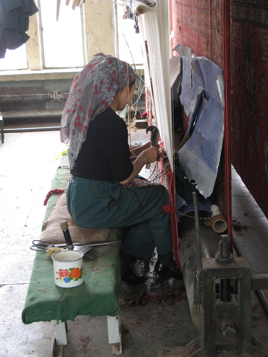 Niya - Hotan - Karghilik - Yarkan - Yengisar, Carpet Factory Workers see the pattern through the carpet.