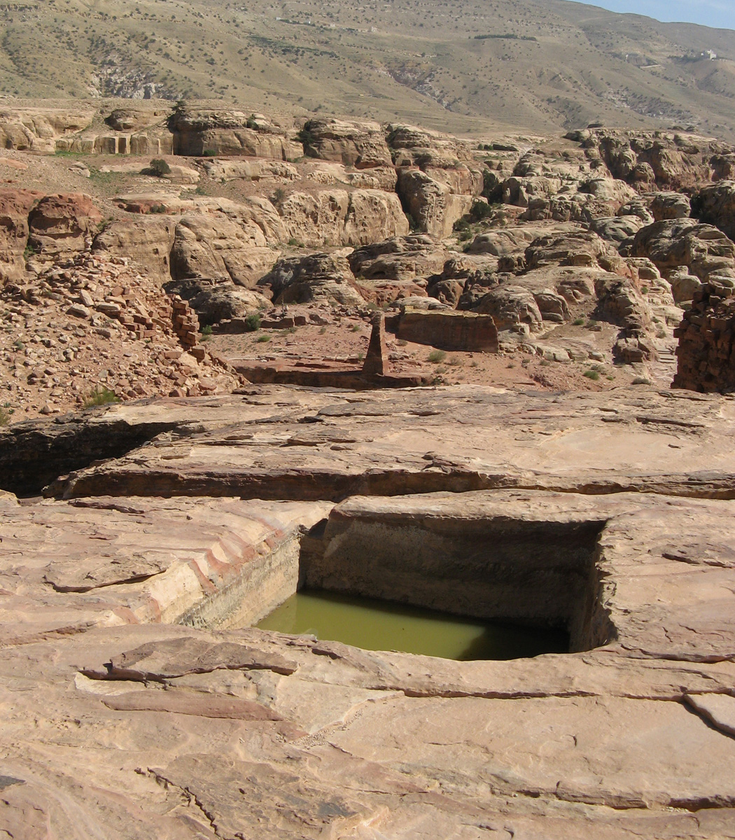 Petra Day-1, Rock-cut cistern Small obelisk in background.