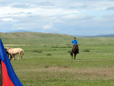 My guide, test-driving a horse. At stop for mare's milk, Central Mongolia, Mongolia 2011