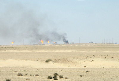 Flares from oil wells. 30 miles W. of Basrah, Nasiriyah, Mesopotamia 2012