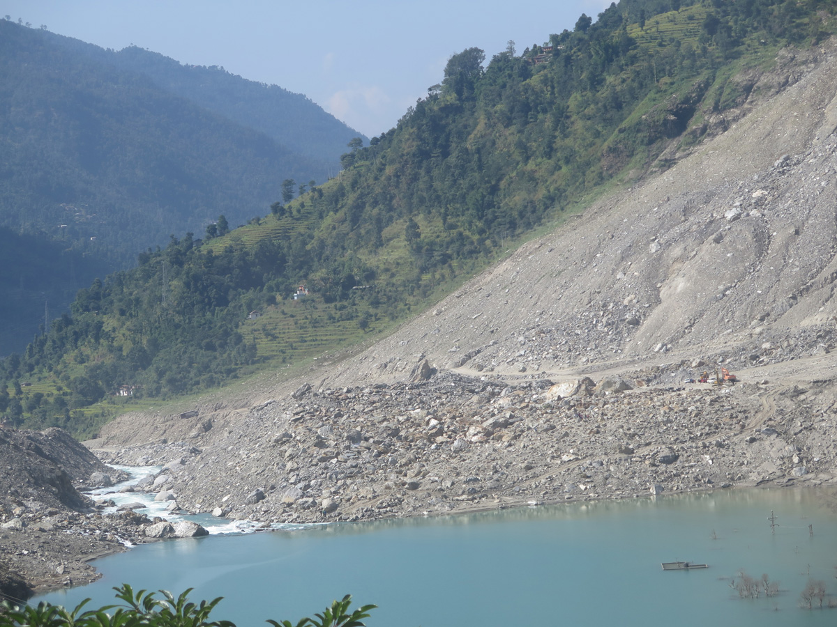 Tibet border to Kathmandu, Lake formed by devastating landslide Note rooftop and pylon tops in lake.