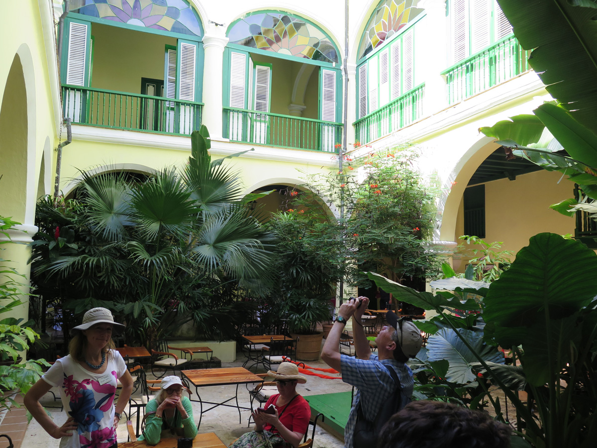 Old Havana, A restored building courtyard Tour leader Hilary on the left