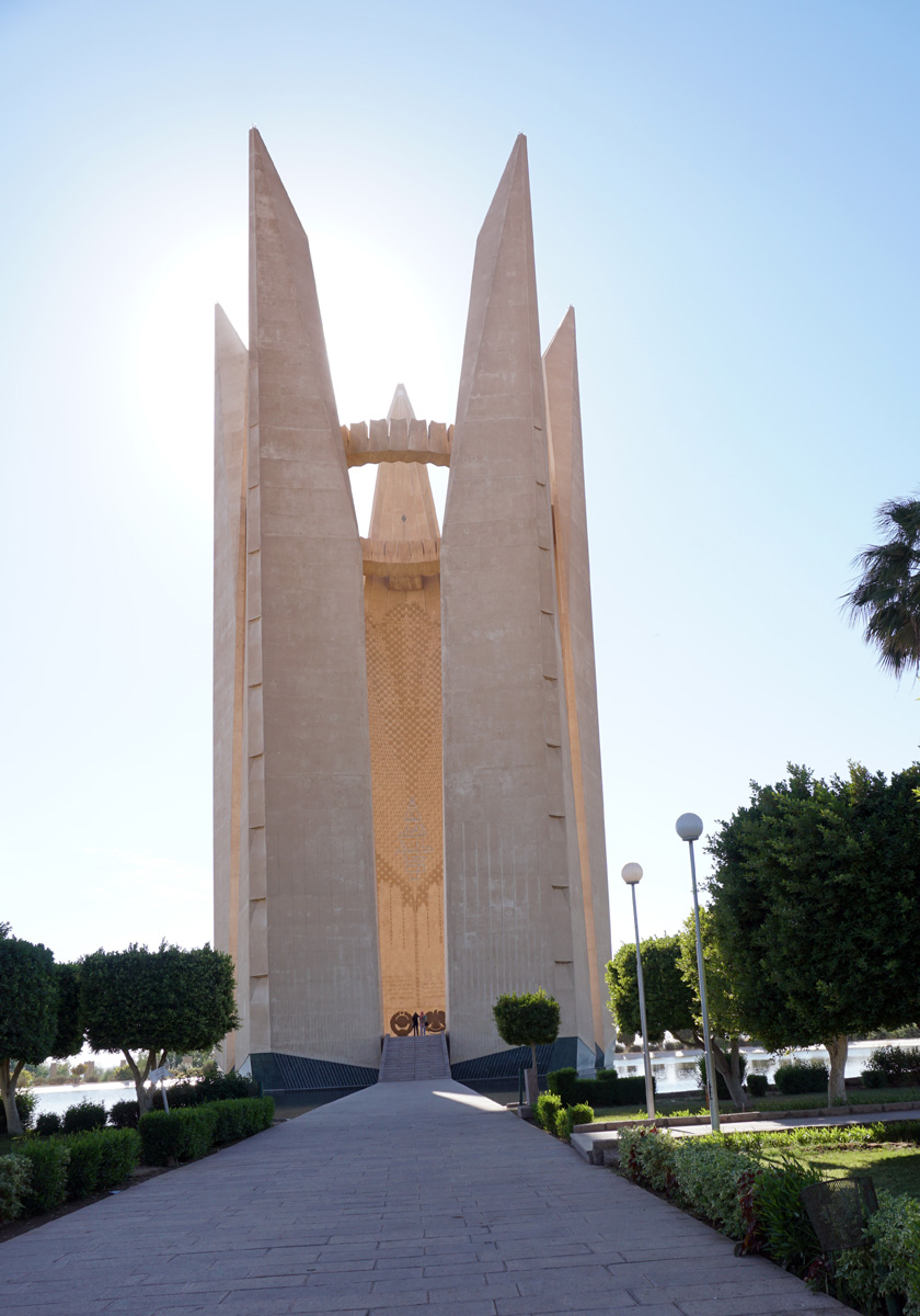 Aswan Dam, Soviet-Egyptian Engineering Monument Lotus leaves, holding up a cog wheel.