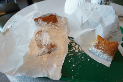 Beignets buried in sugar At a Cafe du Monde outpost, Louisiana May 2021