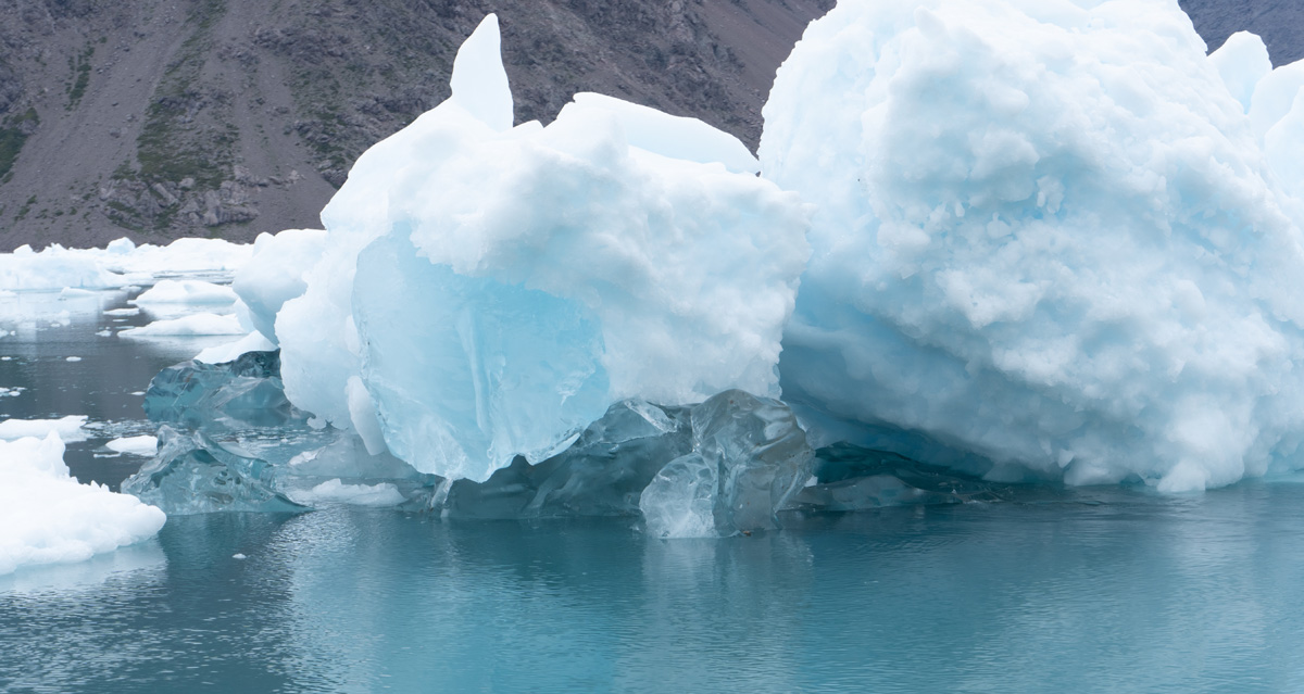 Narsarsuaq: Cruise to Qooroq Icefjord, Clear (refrozen) ice at base of berg The bergs are white due to many tiny air bubbles