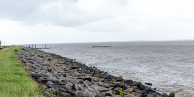Seawall on Courantyne River Estuary With hazy glimpses over to, Tour to Nieuw Nickerie, 2022 Suriname