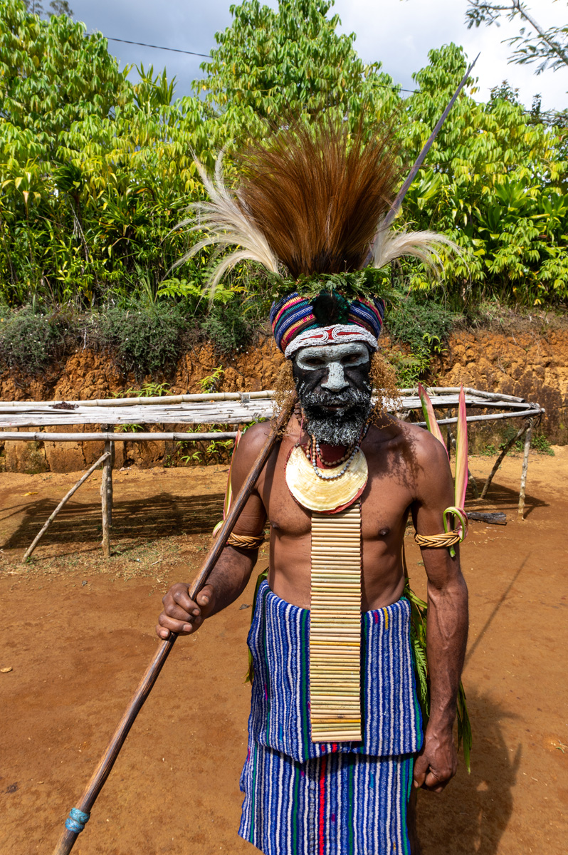 Rondon Ridge Day One: Cultural Shows, A "Chief" Hanging markers indicate pigs killed