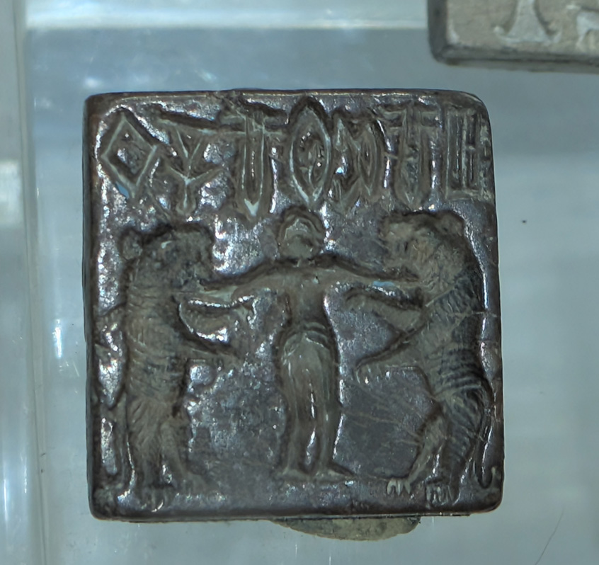 Delhi: National Museum, Small seal stamp, Harappa, ~2700 BC Possibly "Gilgamesh holding two tigers"