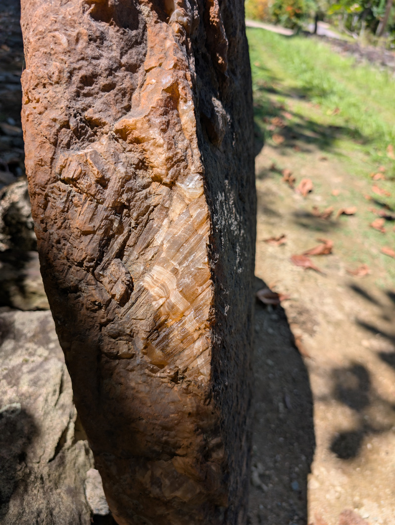 Yap - Land of Stone Money, Clean-cut edge on weathered stone