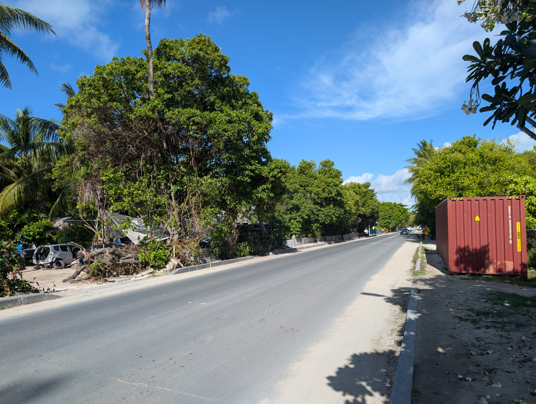 Tarawa, Republic of Kiribati, Island ring road With many trees & omnipresent shipping containers